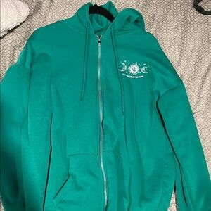 green Zip-Up Hoodie with Sun and Moon Design